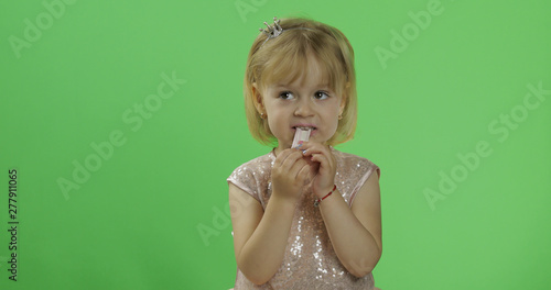 Φωτογραφία Girl in glossy dress begins to eat chewing gum