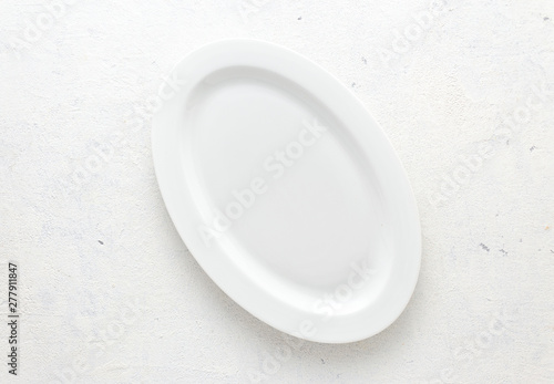 Empty white plate on a white background top view