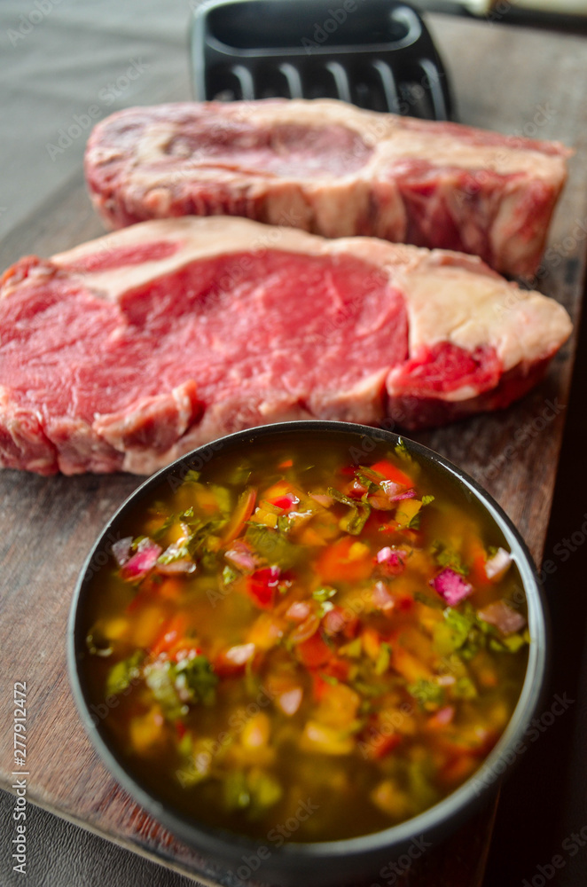 Raw meat and chimichurri sauce