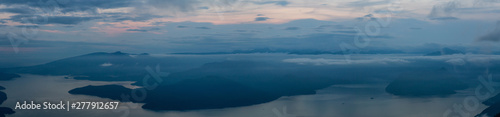 Beautiful Panoramic View of Canadian Mountain Landscape covered in clouds during a vibrant summer sunset. Taken on top of St Mark's Summit, West Vancouver, British Columbia, Canada.