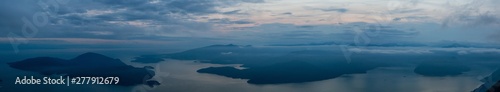Fototapeta Naklejka Na Ścianę i Meble -  Beautiful Panoramic View of Canadian Mountain Landscape covered in clouds during a vibrant summer sunset. Taken on top of St Mark's Summit, West Vancouver, British Columbia, Canada.