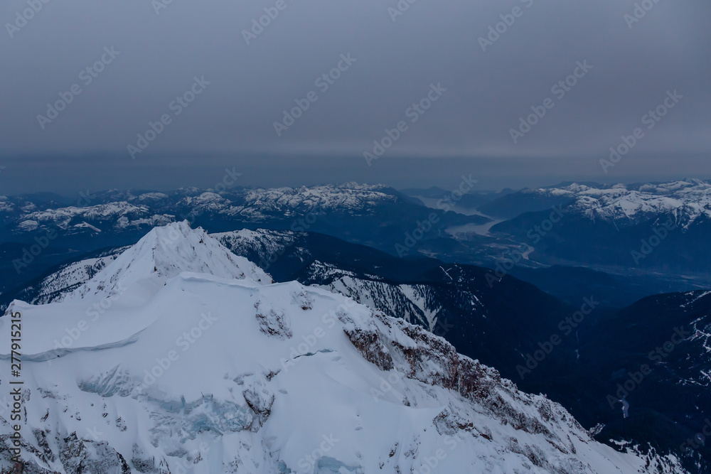 Beautiful Aerial View of Canadian Mountains Landscape during a dark and cloudy evening. Taken near Squamish, North of Vancouver, British Columbia, Canada.