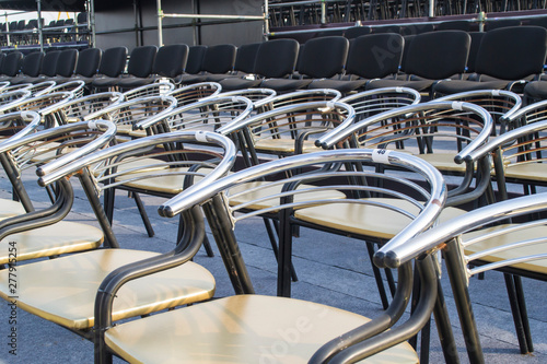 Empty chairs at a concert venue close-up.