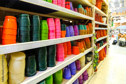 Multi-colored pottery and plastic flower pots are on shelves in Mohazin, a sick choice