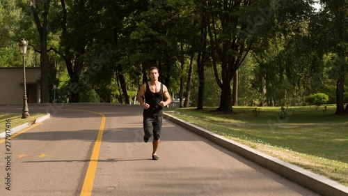 Wallpaper Mural Man running in Park sunny day Follow shot video. Sportsman Runner Athlete training  Torontodigital.ca