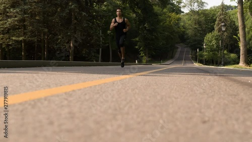 Wallpaper Mural Man running in Park sunny day Follow shot Bottom view video. Sportsman Runner Athlete training  Torontodigital.ca