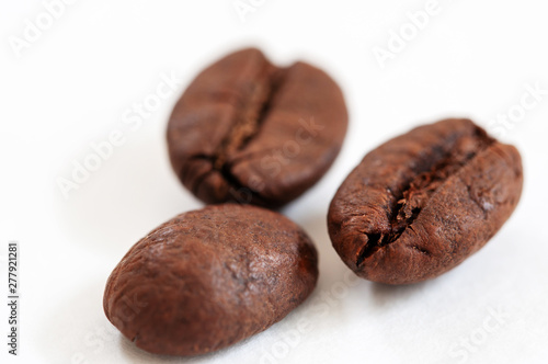 three coffee beans on white background