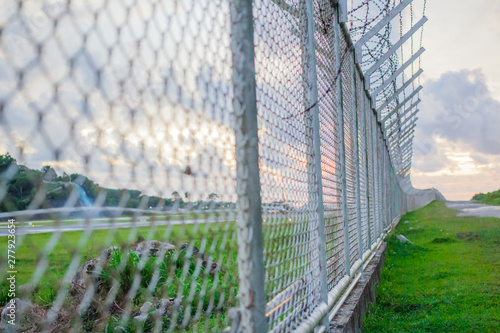 wire mesh steel with green grass background in Phuket Thailand © Stock.Foto.Touch