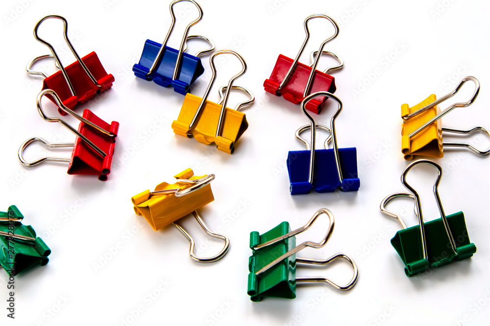 Colored paper clips isolated on white background. School and office accessories. Colored paper clips isolated on white background. School and office accessories.
