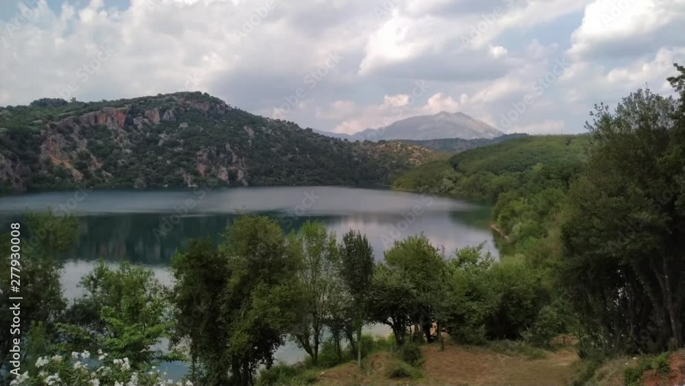 View of a lake in the mountains of Greece. Clouds moving above the water. Timelapse shot. View of a lake in the mountains of Greece. Clouds moving above the water. Timelapse shot.
