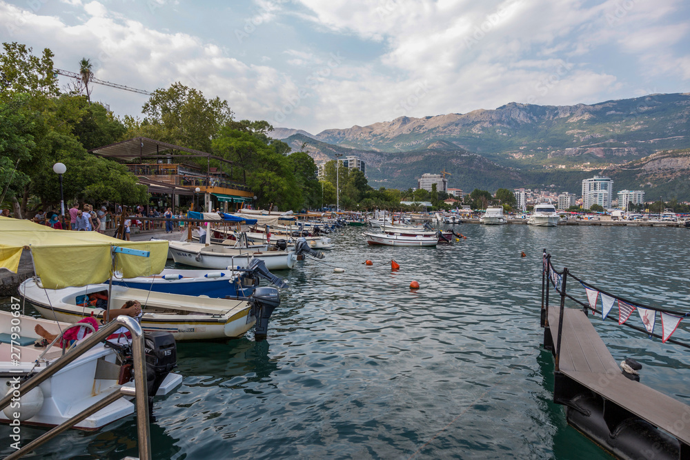 Jetty of boats and yachts on the embankment of Budva