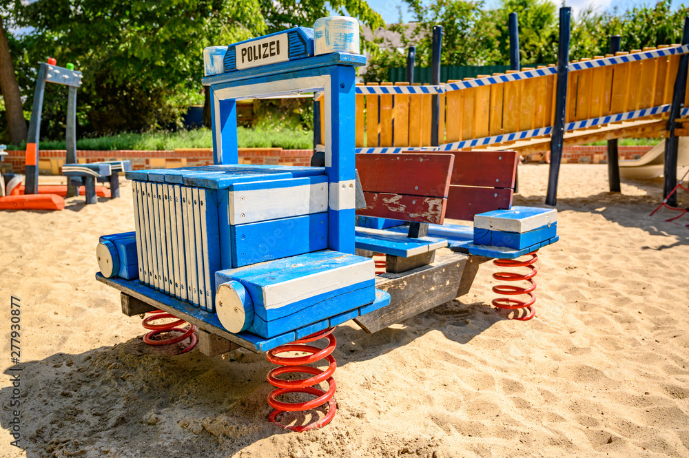 Various wooden playground equipment on a public playground in Berlin with the theme police and rescue. Various wooden playground equipment on a public playground in Berlin with the theme police and rescue.