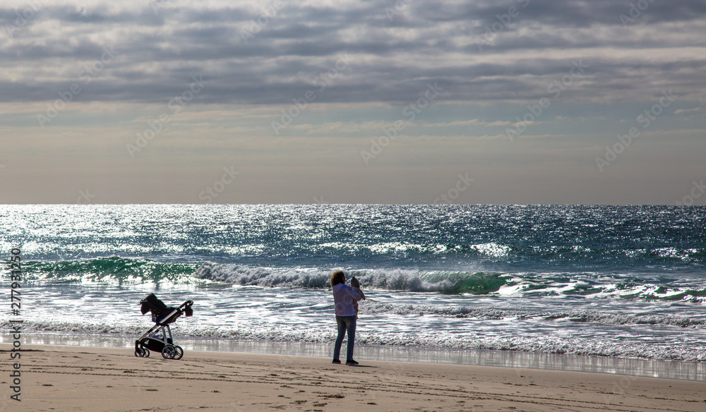 Mulher na praia com seu filho