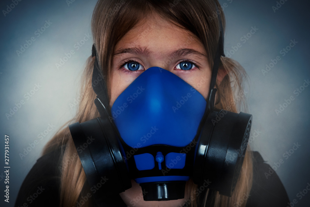 Young girl wearing gasmask, respirator portrait. Effects of worldwide air pollution, industrial influence on environment. Protection from dangerous air particles, gas, smog, transmitted diseases