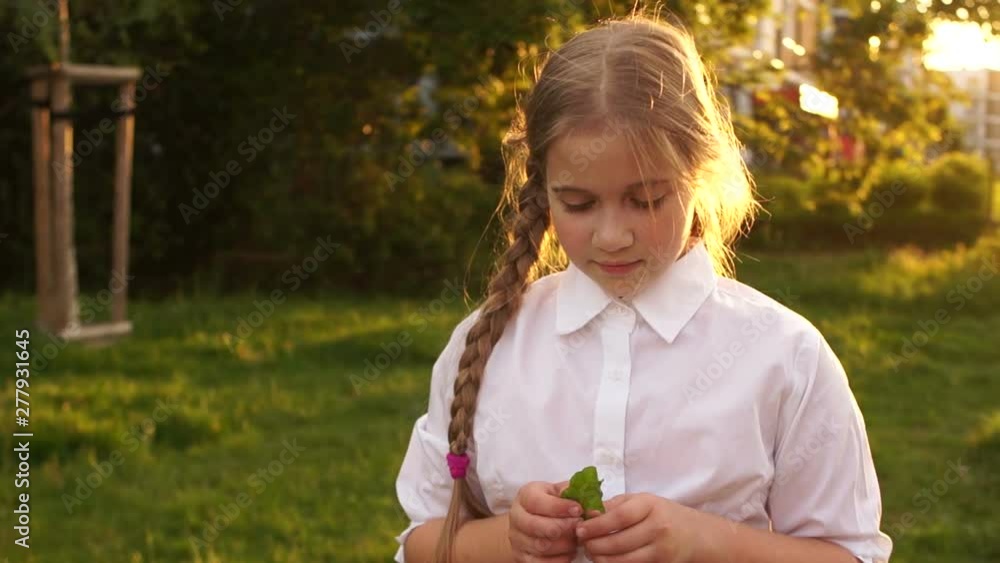 Girl with beautiful hair on a background of nature. Shy teenager in the sun Girl with beautiful hair on a background of nature. Shy teenager in the sun