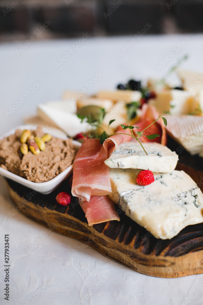 Mix cheese on wooden board with grapes. Top view. Mix cheese on wooden board with grapes. Top view.