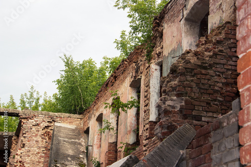 Ensemble of Yaroslavl Big manufactory of 18-19 century. Old building. The ruins of the almshouse and factory buildings among the thickets of trees photo