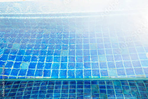 Small blue tile background  in bright light water.