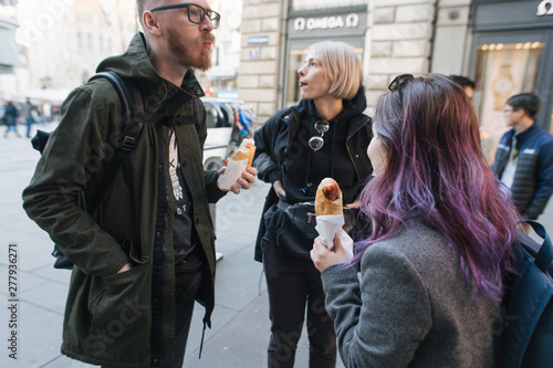 Photography group of tourist are eating fast food in Vienna