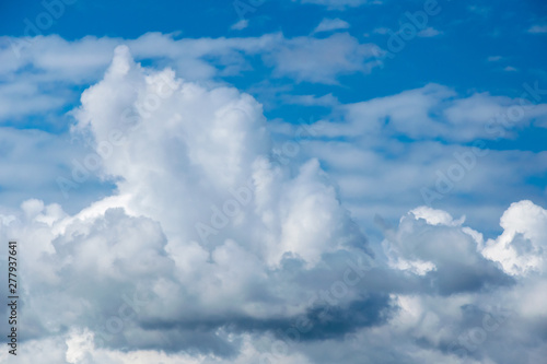 Cumulonimbus clouds on a summer blue sky. Time before a thunderstorm. Abstract background