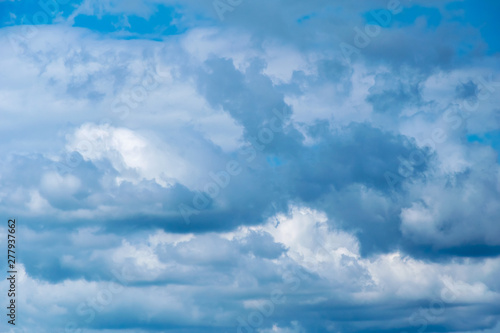 Cumulonimbus  clouds on a summer blue sky. Time before a thunderstorm. Abstract background
