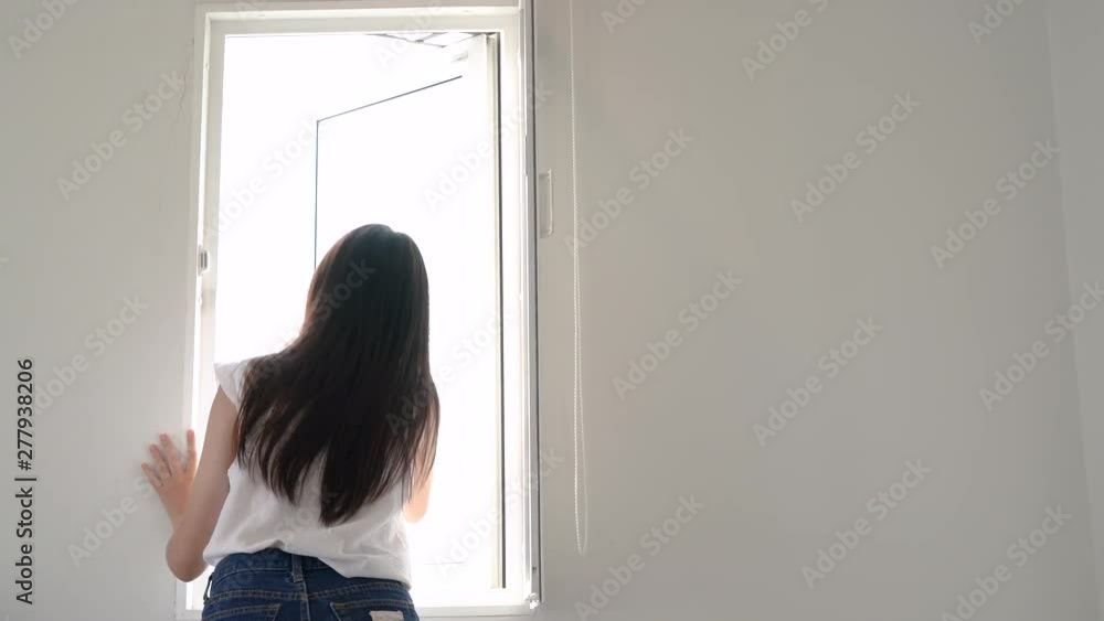 Beautiful asian woman open windows after wake up and look out resting in hotel room at morning. Beautiful asian woman open windows after wake up and look out resting in hotel room at morning.