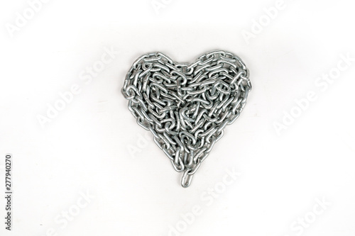 The thick metal chain folded by heart on white background isolated