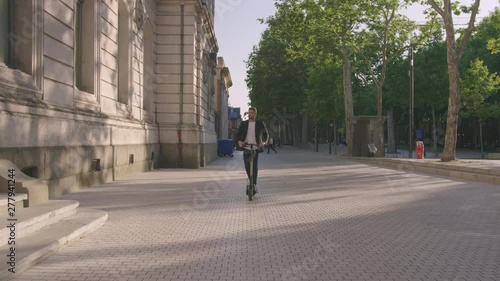 Wallpaper Mural Young Businessman Going To Work by Electric Scooter in City 4 Torontodigital.ca