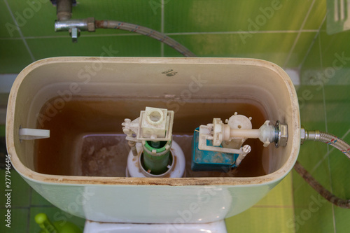 repair toilet valve,open cover of the toilet tank top view, repair toilet waste water