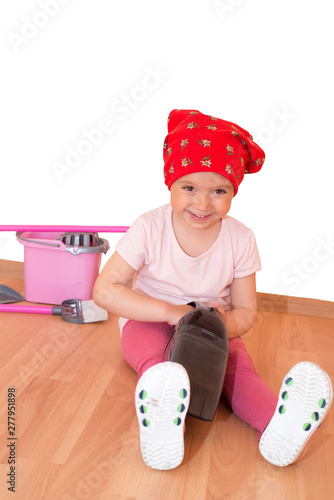 Little girl cleaning up isolated with clipping path photo