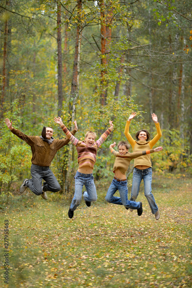 Family of four having fun in forest Family of four having fun in forest