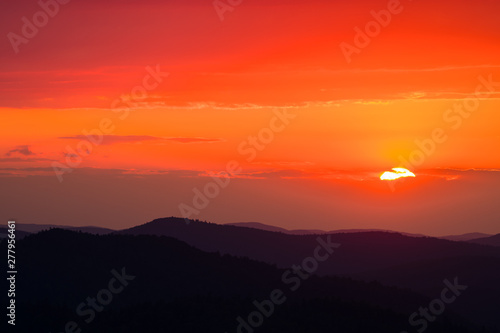 A wonderful sunset in the mountains. Orange sky and dark silhouettes of mountains. Carpathian Mountains landscape. Bieszczady. Poland © Szymon Bartosz