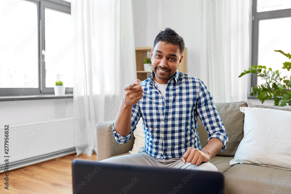 Fototapeta premium blogging, videoblog and people concept - indian male blogger recording video blog at home and pointing to you