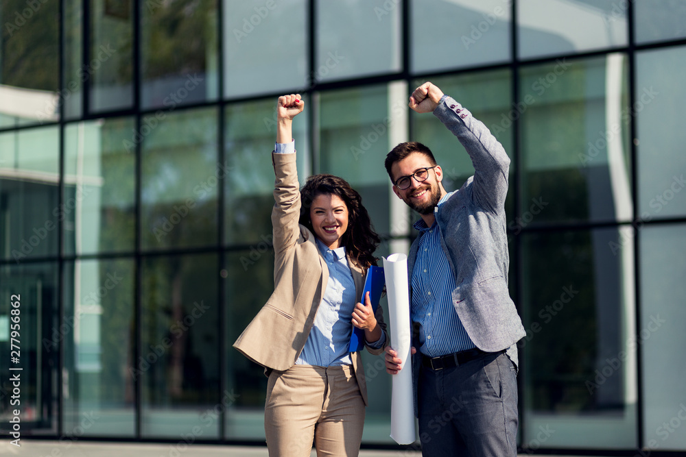 Successful business people with raised hands Successful business people with raised hands