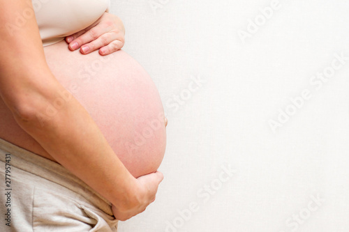 Image of pregnant woman touching her big belly. Motherhood, pregnancy, people and expectation concept. Pregnant woman expecting baby