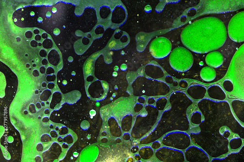 Green liquid bubbles abstract background. Macro photography