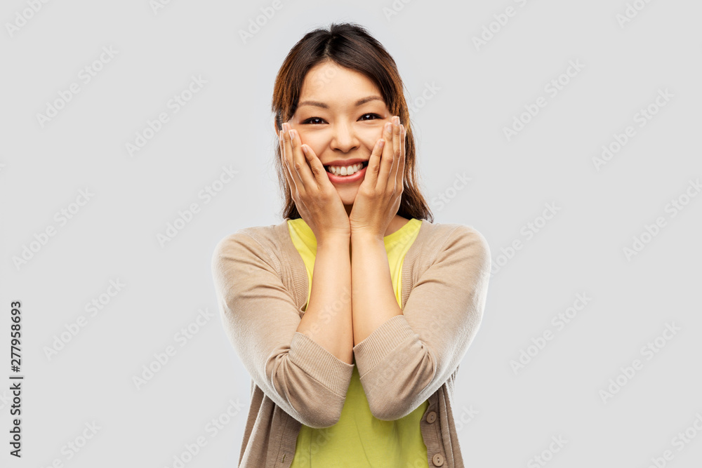 people, expression and emotion concept - happy amazed asian young woman over grey background people, expression and emotion concept - happy amazed asian young woman over grey background