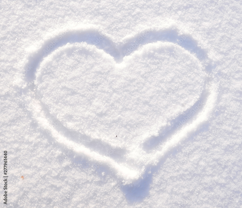 Symbol of heart on the background of fresh snow texture. Merry Christmas or Valentine's Day Concept. Copy space for your text. Symbol of heart on the background of fresh snow texture. Merry Christmas or Valentine's Day Concept. Copy space for your text.