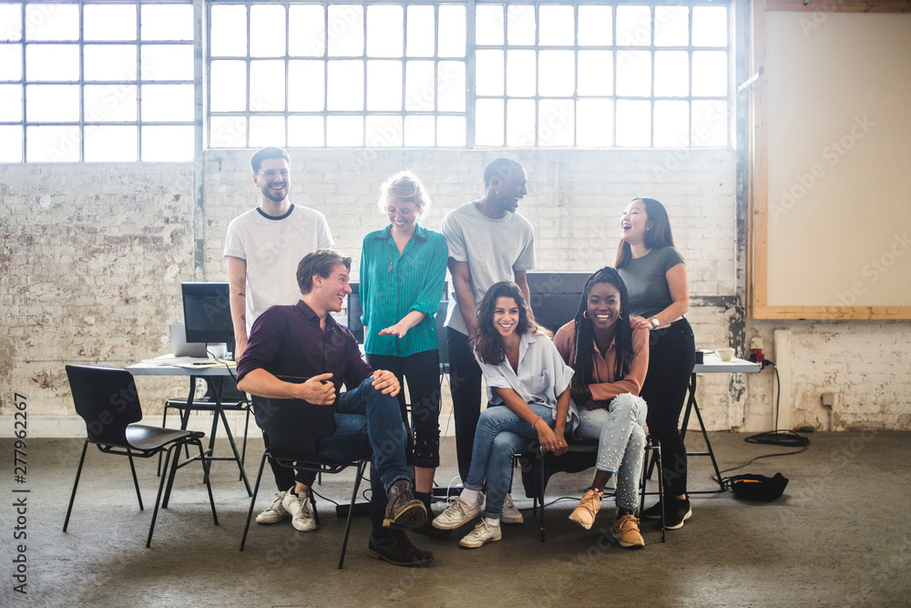 Cheerful young programmer's team enjoying at creative office