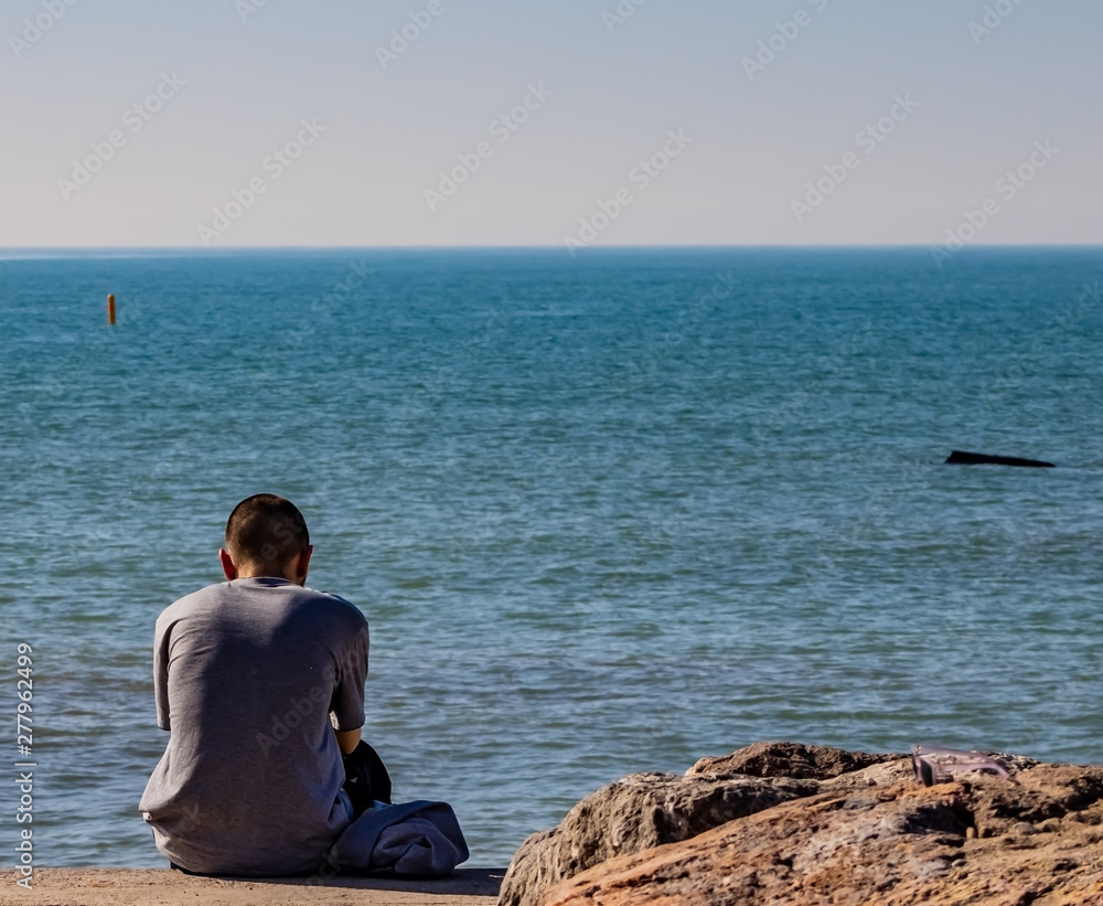 Young man contemplating the Mediterranean sea
