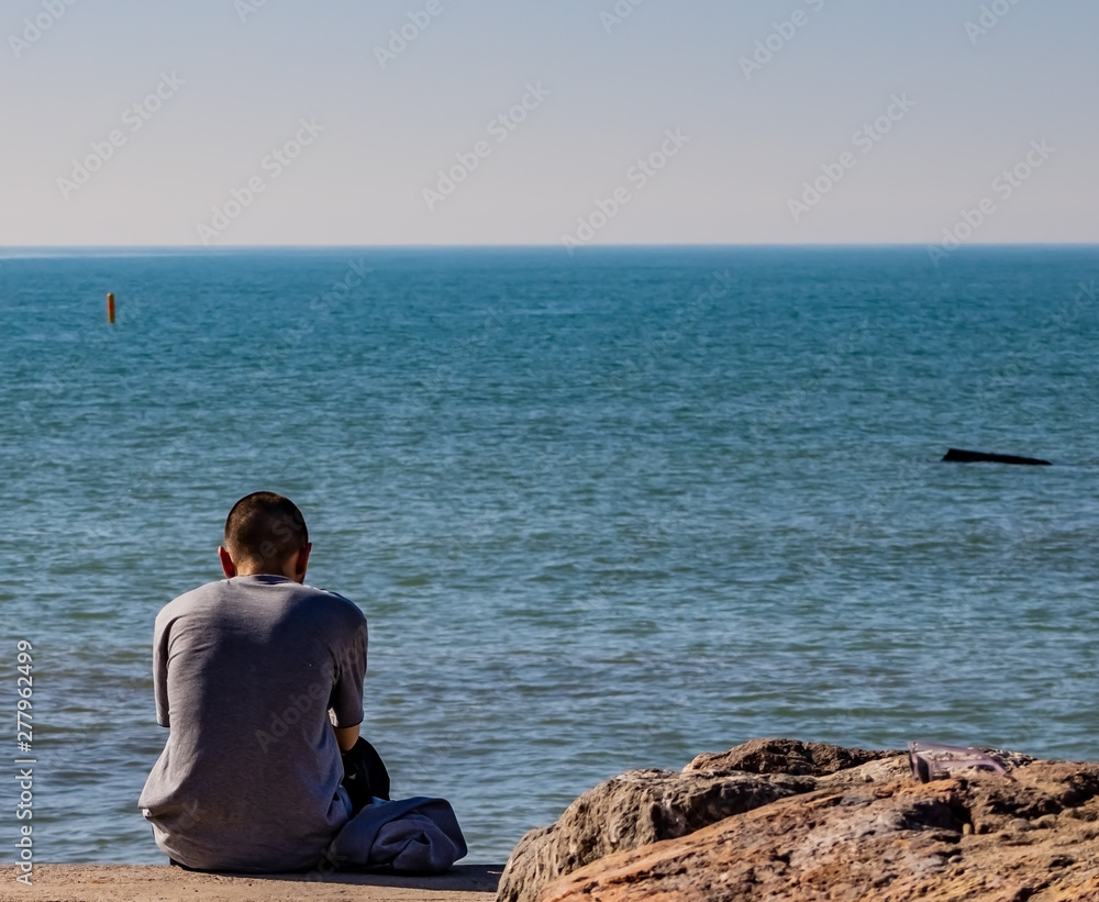 Young man contemplating the Mediterranean sea Young man contemplating the Mediterranean sea