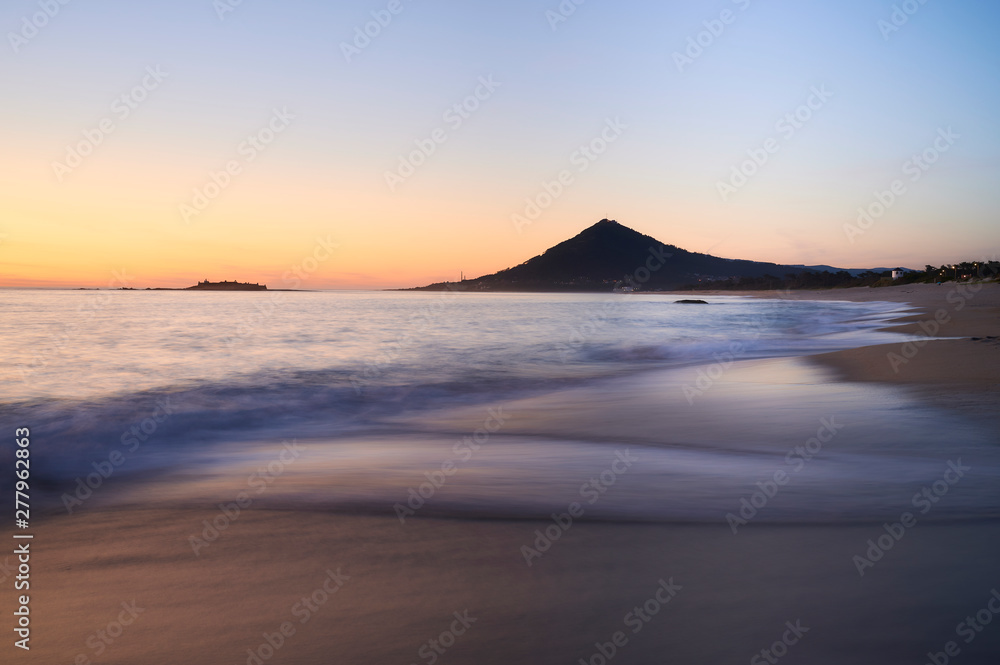 Sunset at the Moledo beach, with a mountain on backgroud