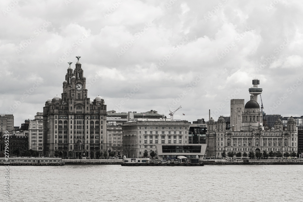 Fototapeta premium Liverpool seafront view from ferry in a summer cloudy day with the royal liver building imposing 