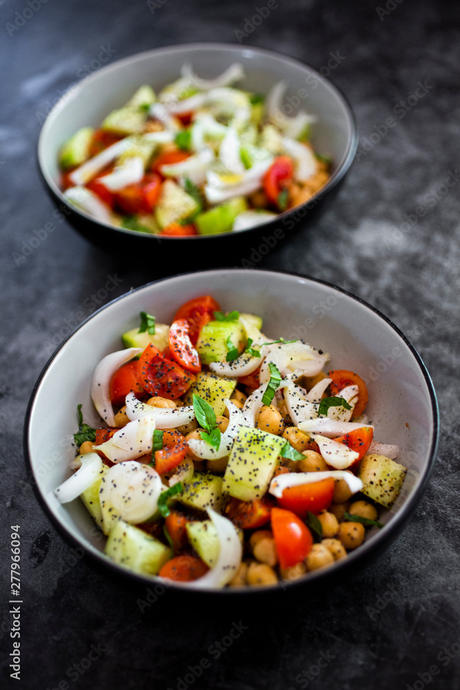 Salad with cucumbers, chickpeas, onion, cherry tomatoes, basil, chia seed Salad with cucumbers, chickpeas, onion, cherry tomatoes, basil, chia seed
