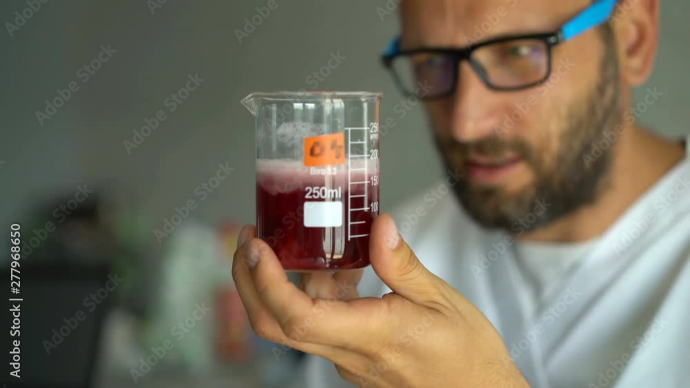 Man scientist doing lab test with chemicals Man scientist doing lab test with chemicals