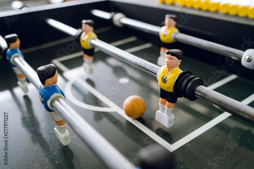 Foto Close up on players of Table football soccer kicker foosball top-table game play