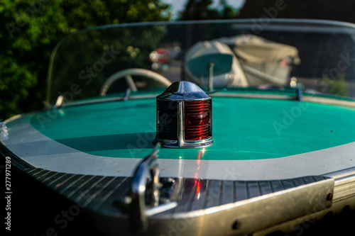 1950 vintage turquoise speed boat with red and green navigation lights chrome bow
