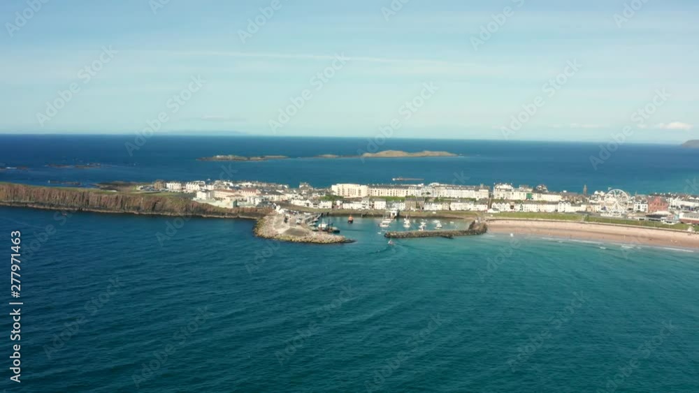 Portrush harbour marina with boat entering through wall, Northern Ireland Portrush harbour marina with boat entering through wall, Northern Ireland