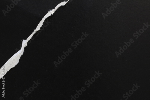 Ripped black paper background, space for advertising copy
