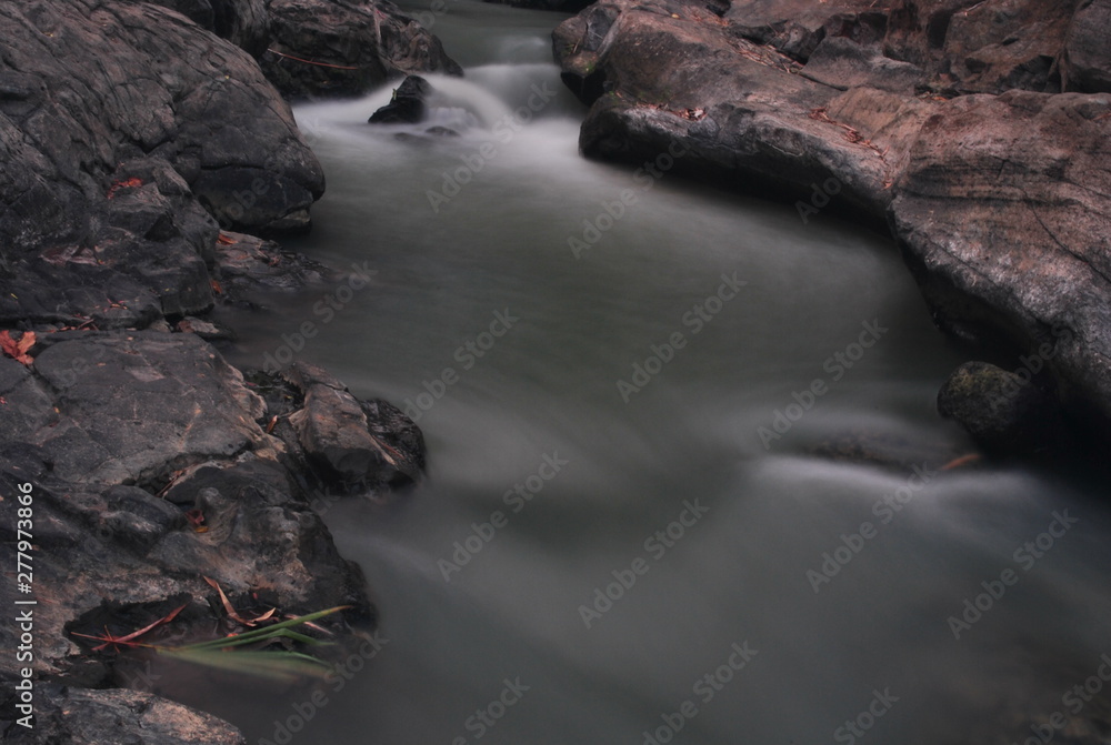 water flow in the river with brown river edges